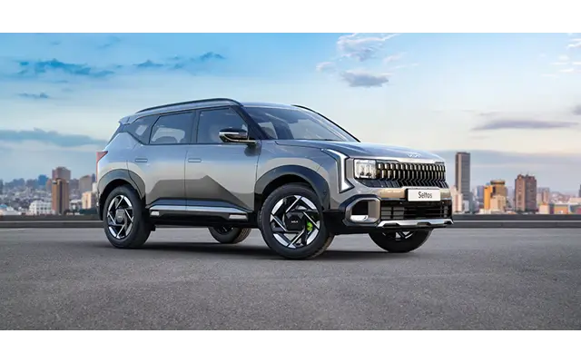 White 2026 Kia Seltos parked in a modern dealership showroom with premium lighting and clean interior design