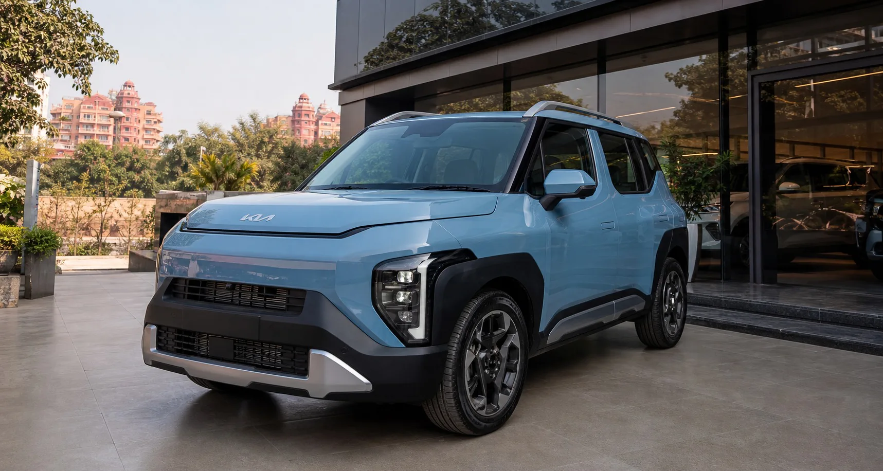 Kia Syros offers Bharatpur hero image showing the Syros outside a Rajasthan dealership for buyers checking live quote timing, variant fit, and booking readiness.