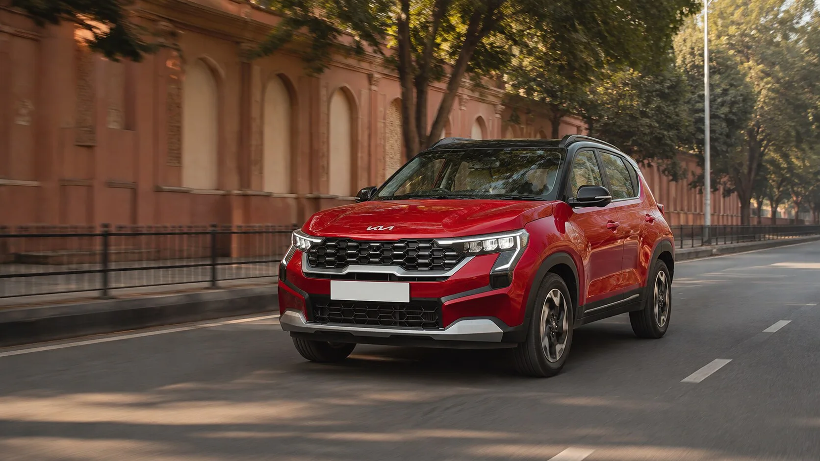 Kia Sonet manual vs automatic Jaipur guide with a red Sonet on a Jaipur urban road